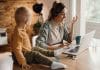 Happy mother having video call over laptop while working at home