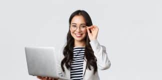 Business, finance and employment, female successful entrepreneurs concept. Confident smiling asian businesswoman, office worker in white suit and glasses using laptop, help clients