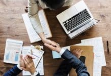 Business people shaking hands together